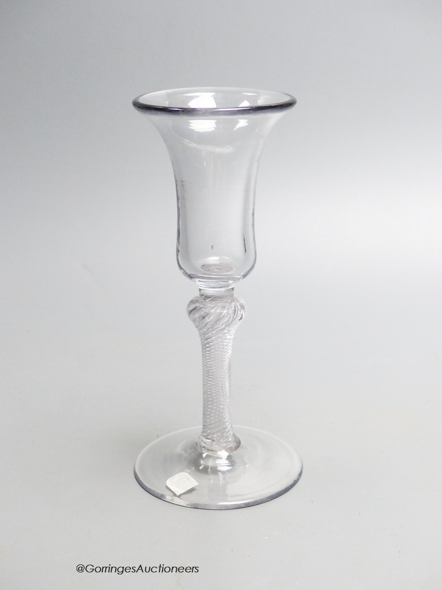 A Georgian air twist stem wine glass c.1750, a bell shaped bowl. 17cm